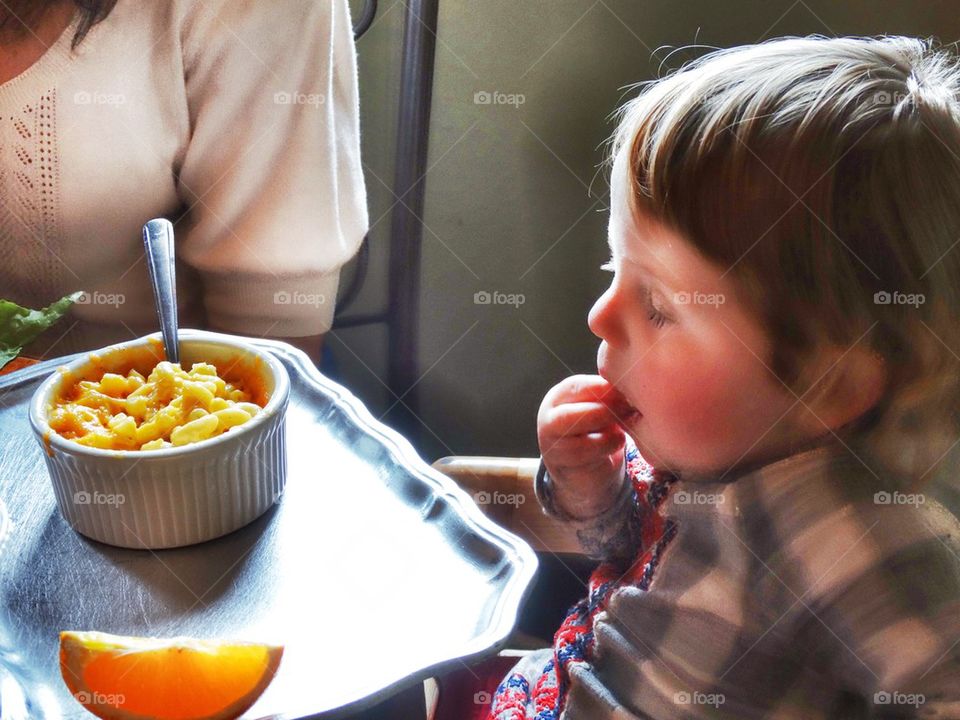 Toddler Learning To Eat. Young Boy Eating Macaroni And Cheese
