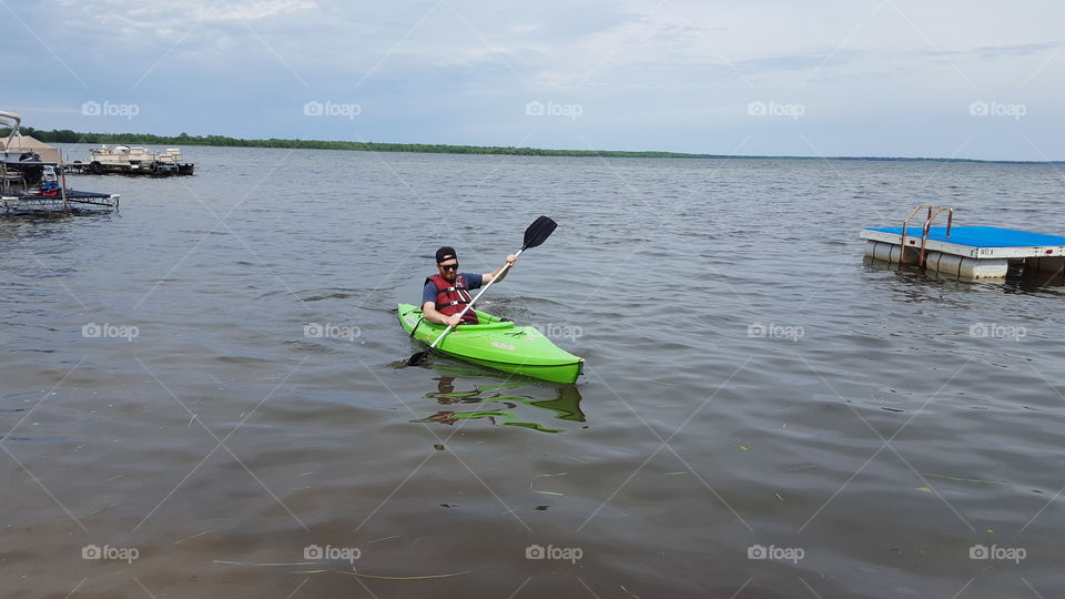 man on green kayak on Lake