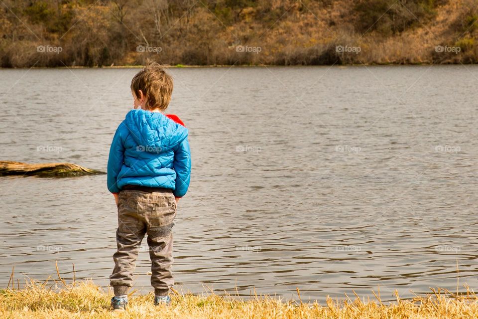 Minimalism - boy at water's edge