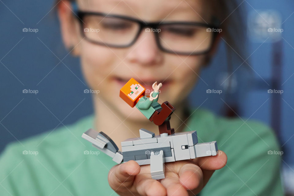 Child showing off her Lego dolphin