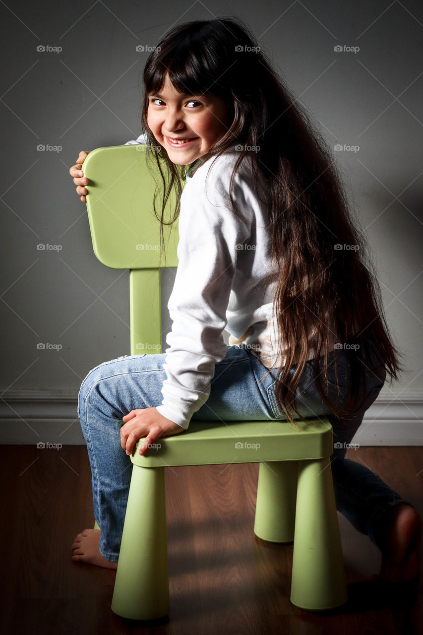 Cute little girl on her favorite chair