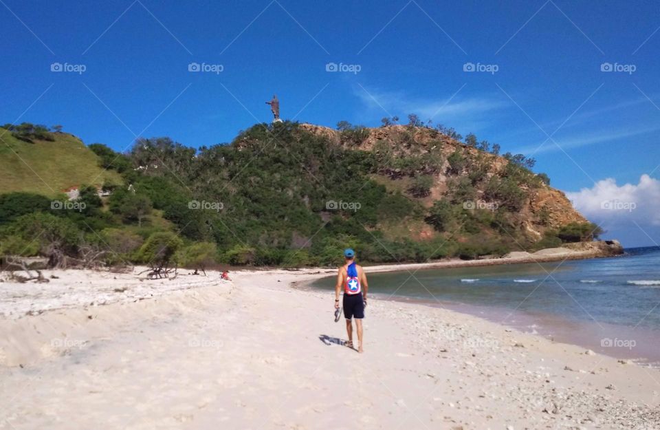 Walking towards Cristo Rei at Dolok Oan beach,  on a sunny beautiful day