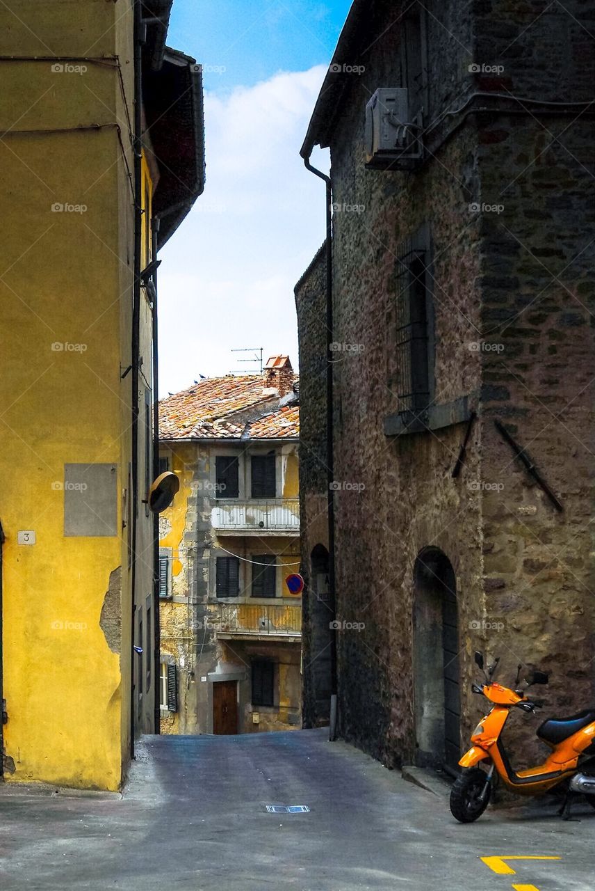 Orange scooter in Yellow street