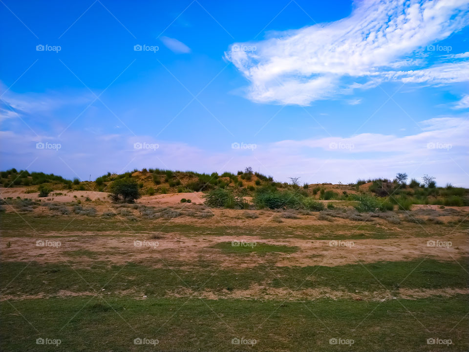 Beautiful landscape with field on backdrop blue sky