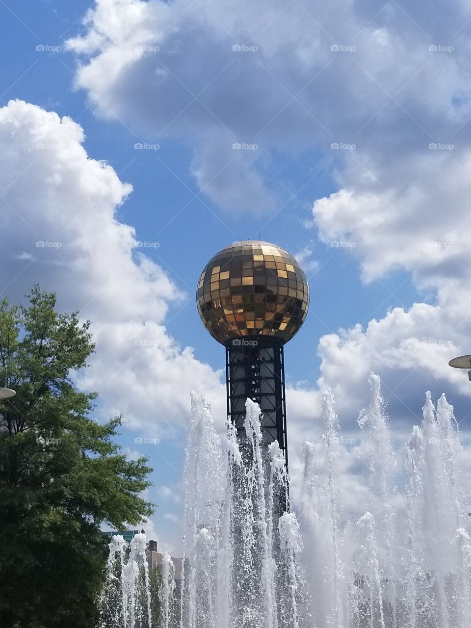 Sun Sphere in Knoxville with a fountain splashing up in front of it.