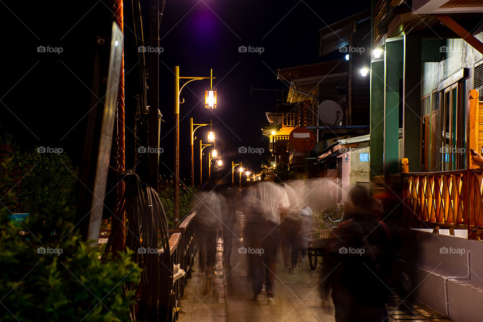 Blurry tourists on the street at Walking Street Chiang Khan, Loei in Thailand.