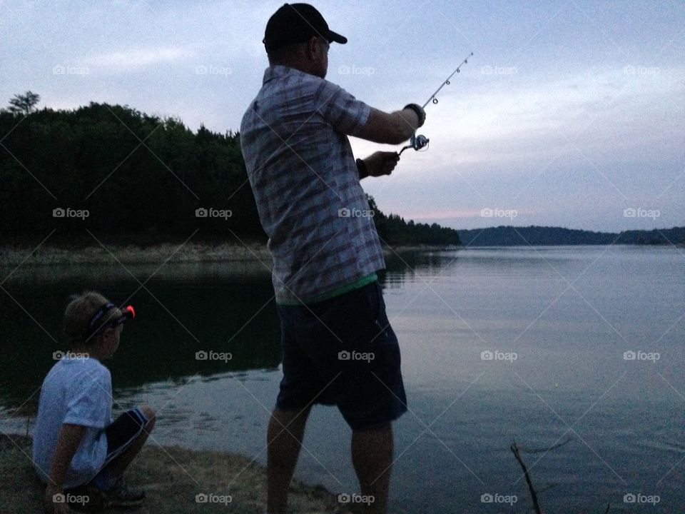 Father and son fishing. Night fishing 