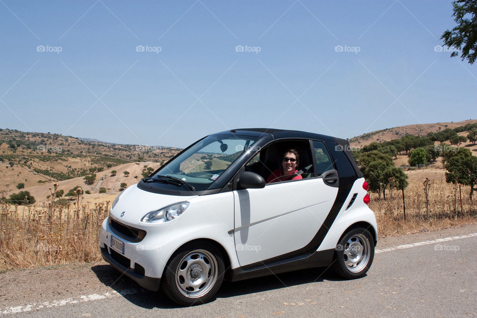 Man driving a smart car 