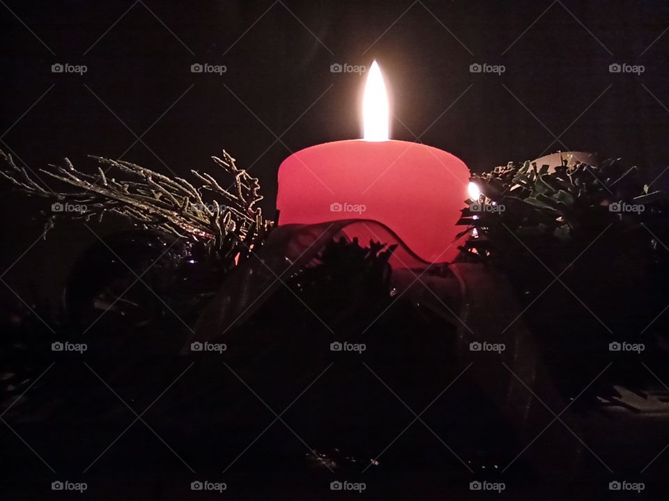 A photo of flamed candle on the advent wreath