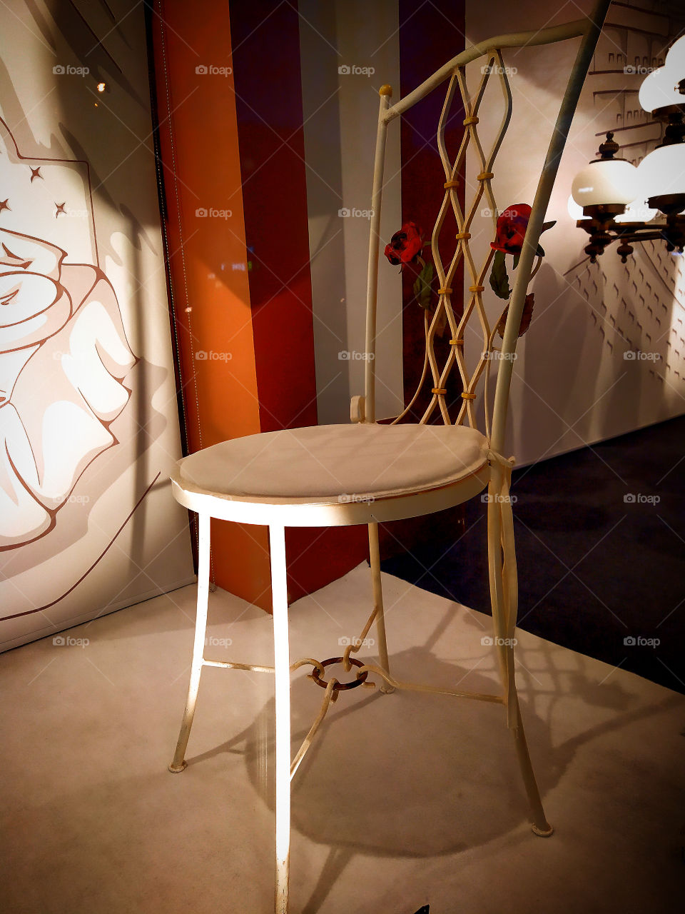 Country wooden chair, on the back of which there are two red roses