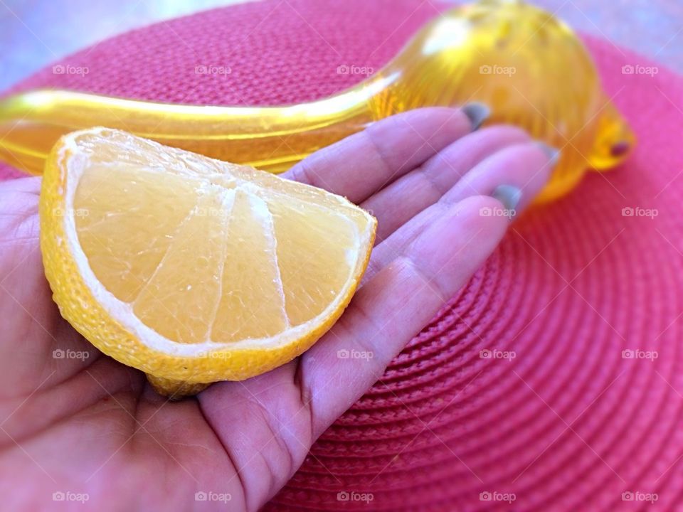 Close-up of lemon in hand