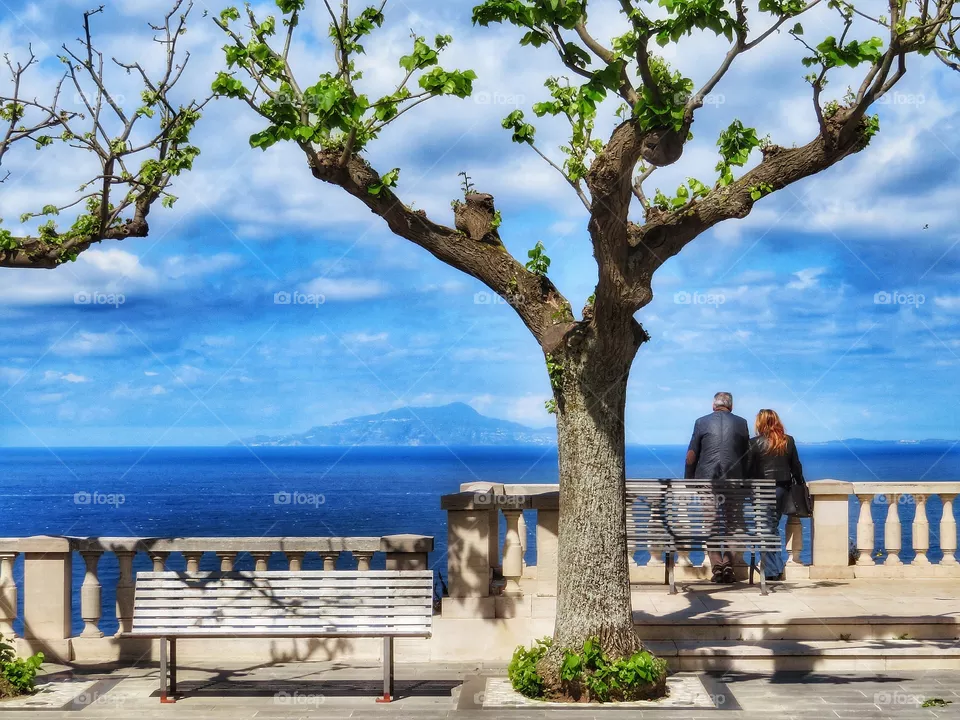 Couple looking at the Islands of Ischia and Procida from Massa Lubrense