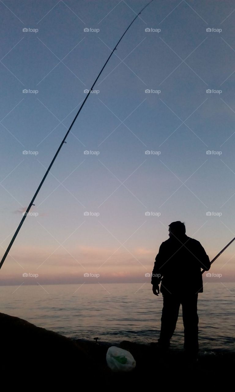 Fishing dusk and sea