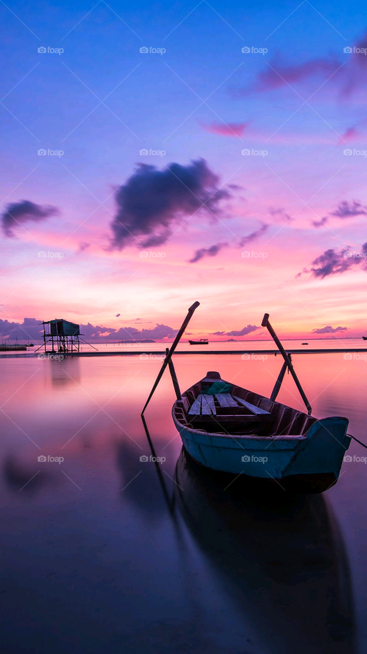 Boat in the pink sea