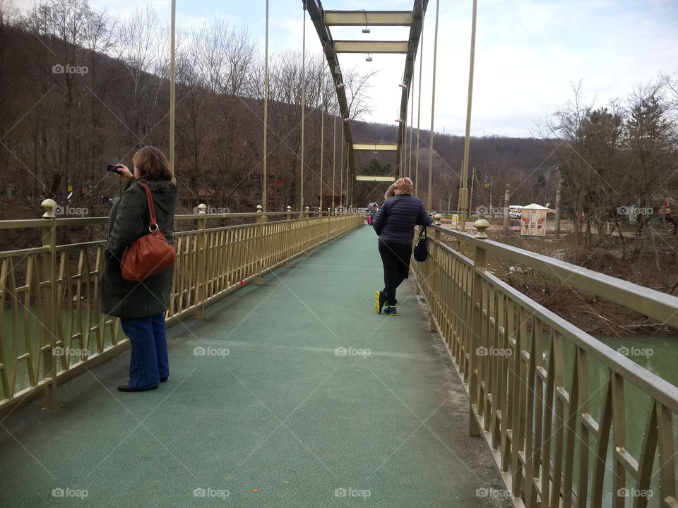 pedestrian bridge over a mountain river in the winter resort of