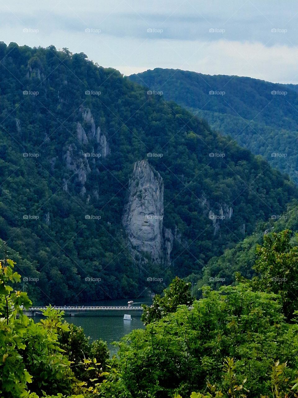 the rock sculpture of Decebal's face seen from the Serbian shore