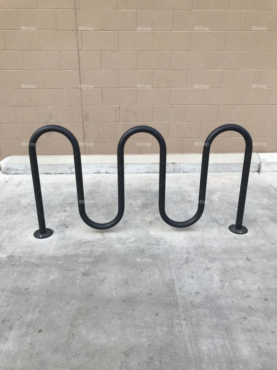 A bicycle rack located outside a retail store.