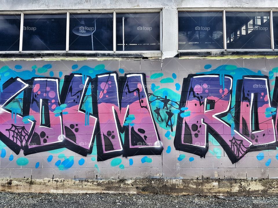 Bright coloured Graffiti on old brick wall