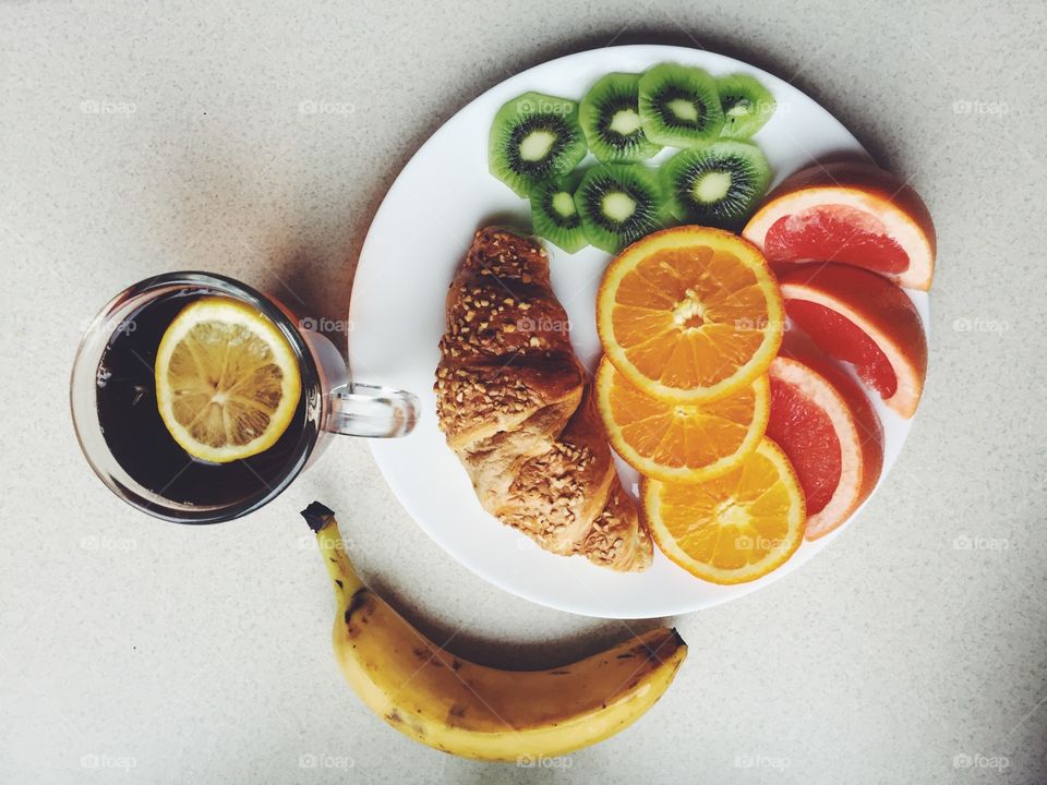 High angle view of fruits with croissant