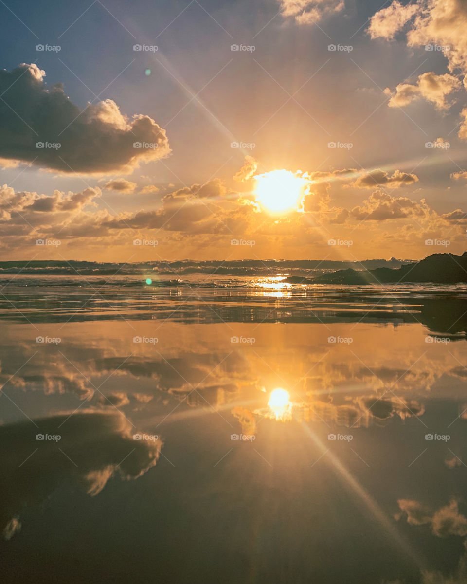 Reflection of a sunset on the beach 