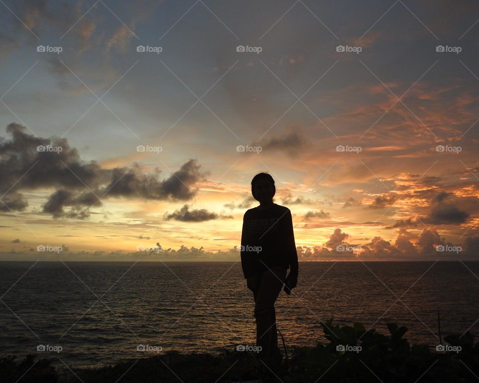 someone standing on the edge of a cliff.