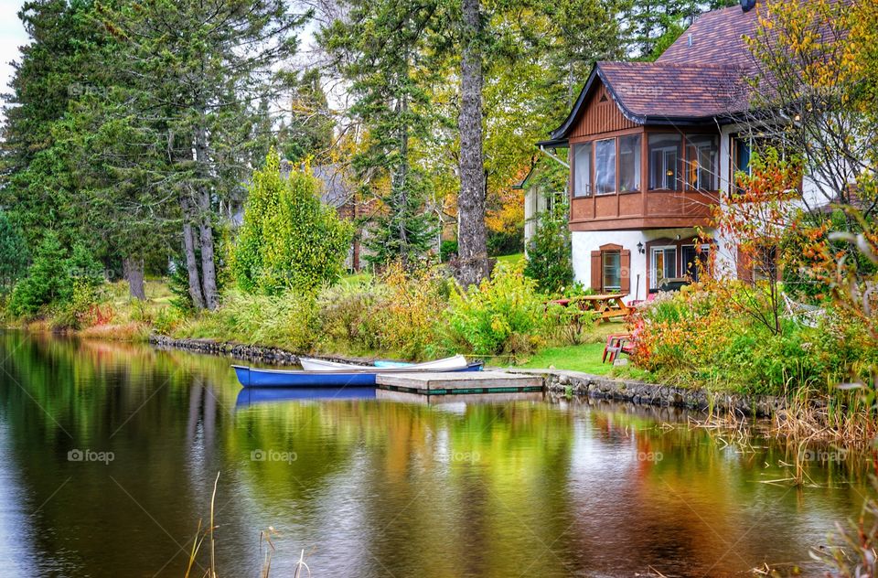 Cottage on a lake with vivid fall colors