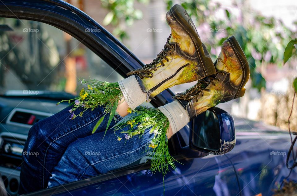 What's that doing here 😃? Woman Lying in Car With her Feet Out of Car Window. She Have Flowers Inside the Boots