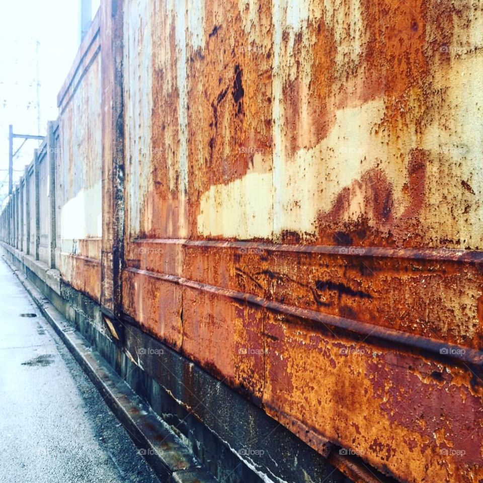 Rusted metal along a city street, color and texture 