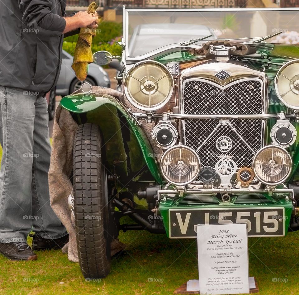 A 1933 Riley 9 March Special in British racing green being care for by its owner