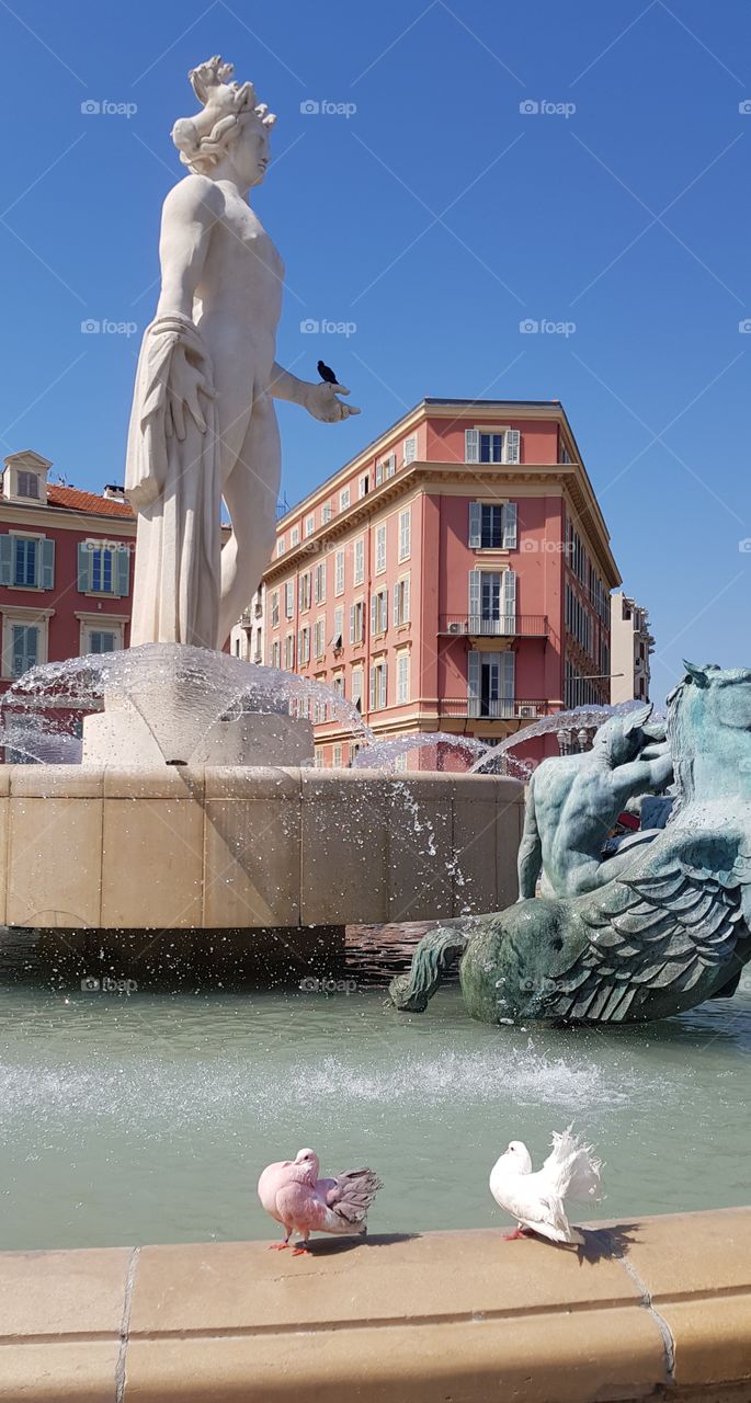 Fountain with pink and white birds at place Massena in Nice,  France.