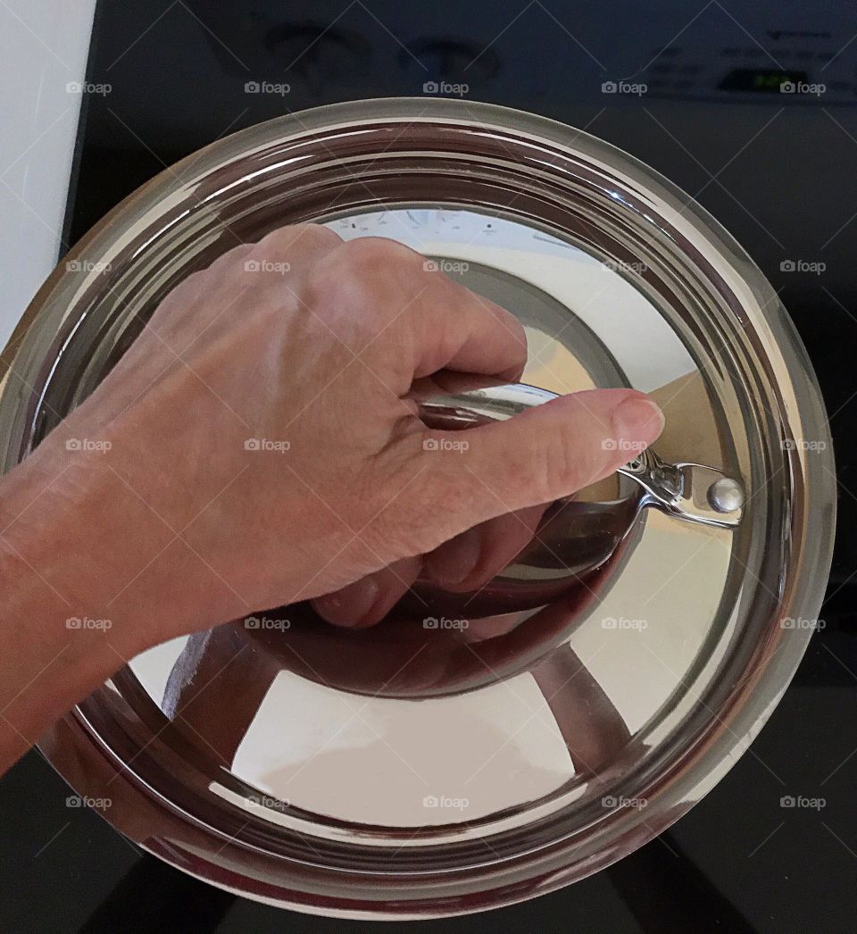 Close-up of person's hand holding cooking pan