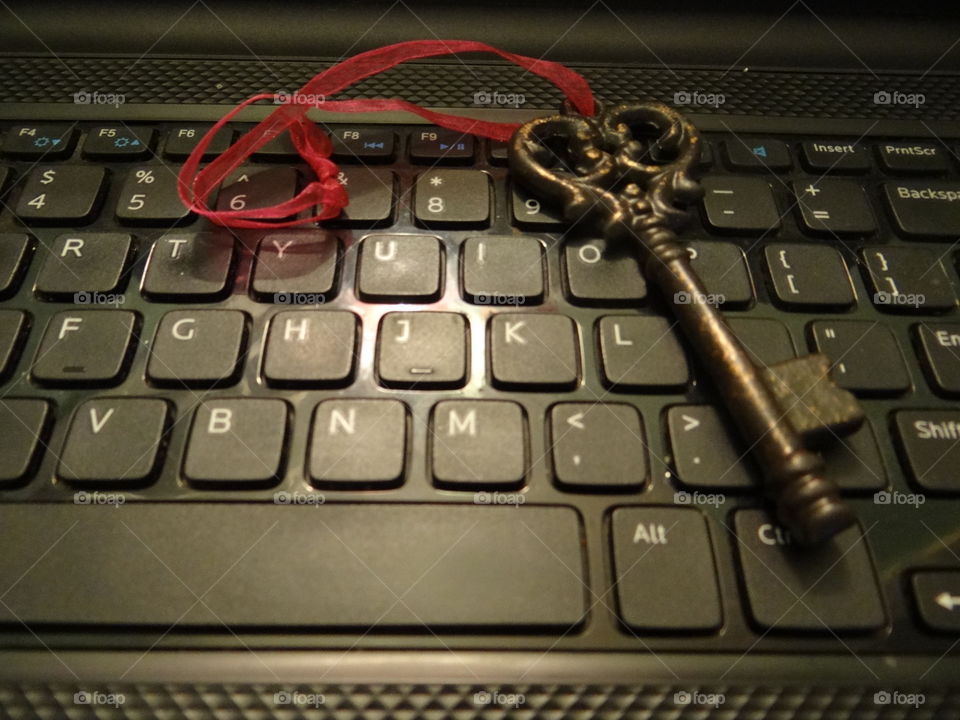 IT Security. Old key, computer keyboard