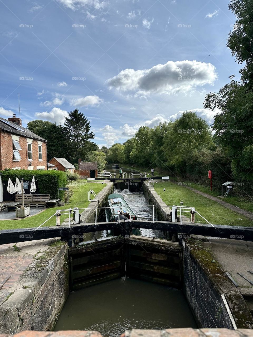 Brauston lock by Admiral Nelson pub narrowboat cruise vacation holiday English countryside Grand Union canal clear sky lovely sunny late summer weather