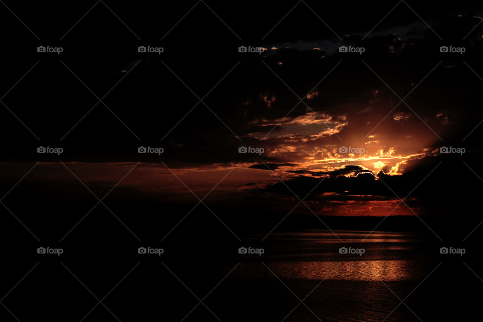 Dark cloudy sunset on the sea