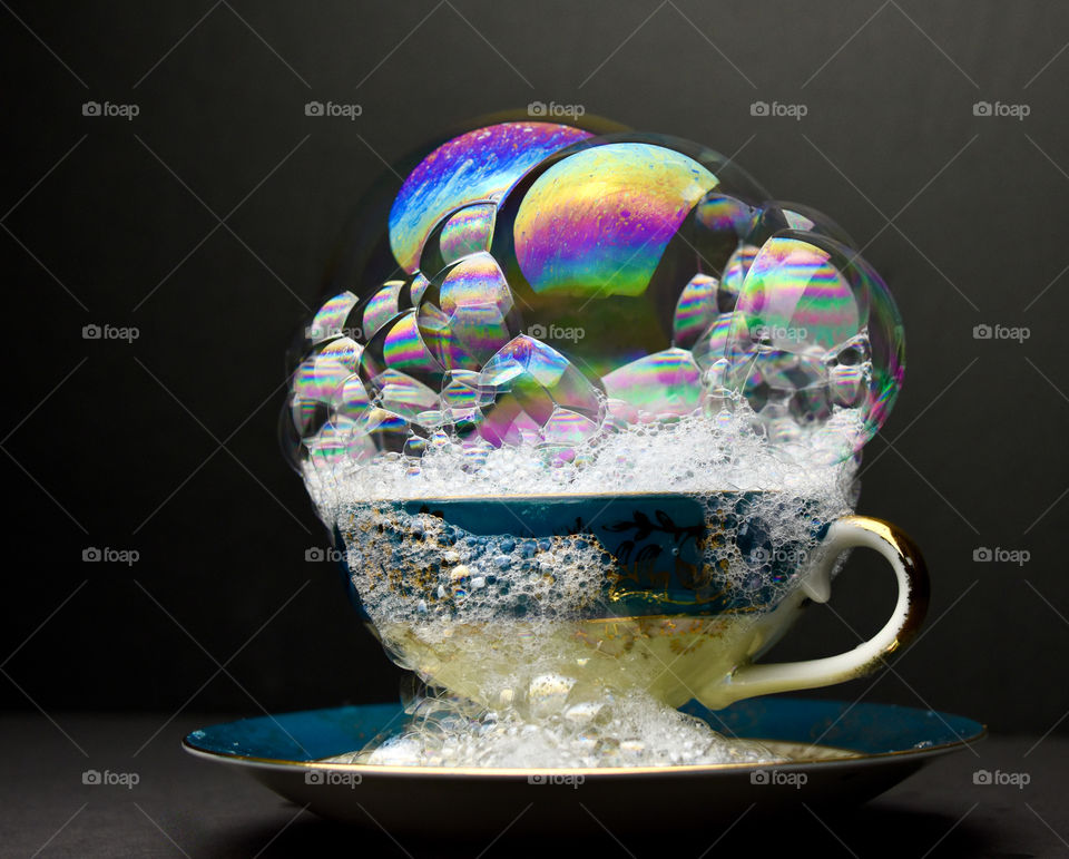 Bubble photography with bubbles in a cup and black background 