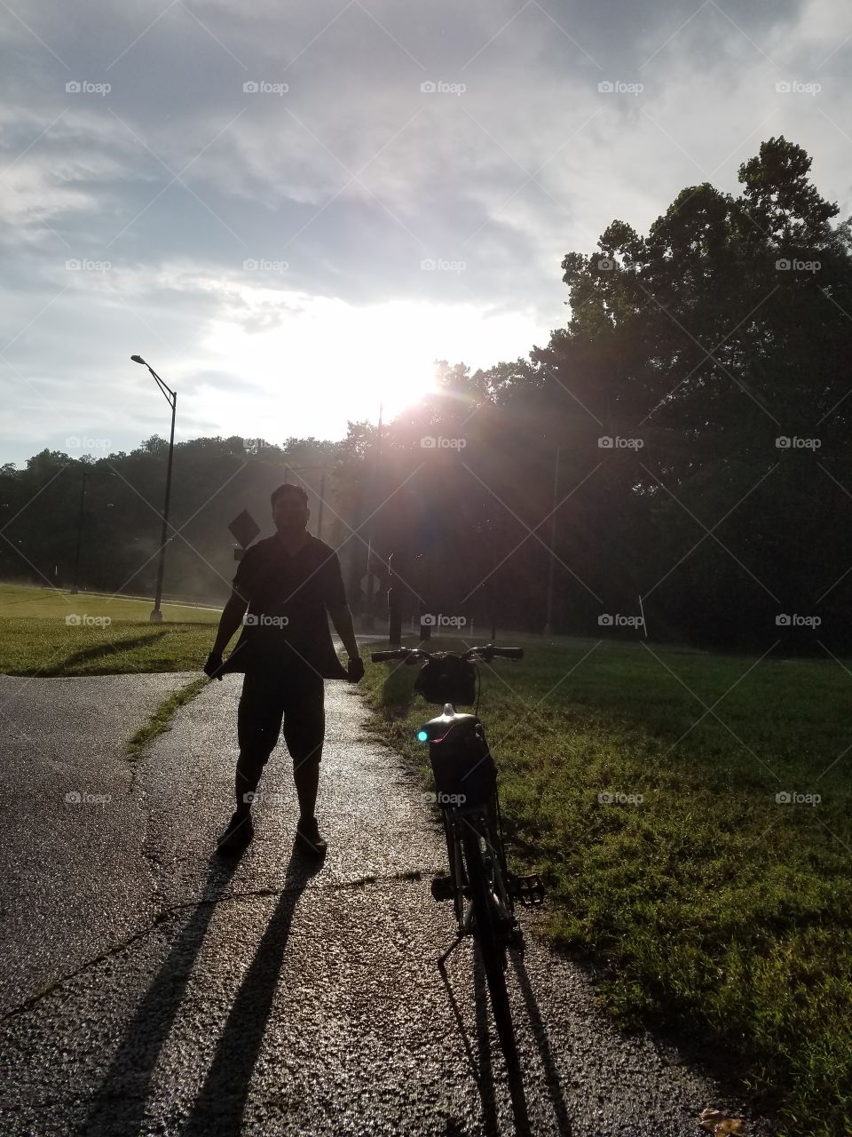 man silhouette in Washington dc as the sun fades past the trees