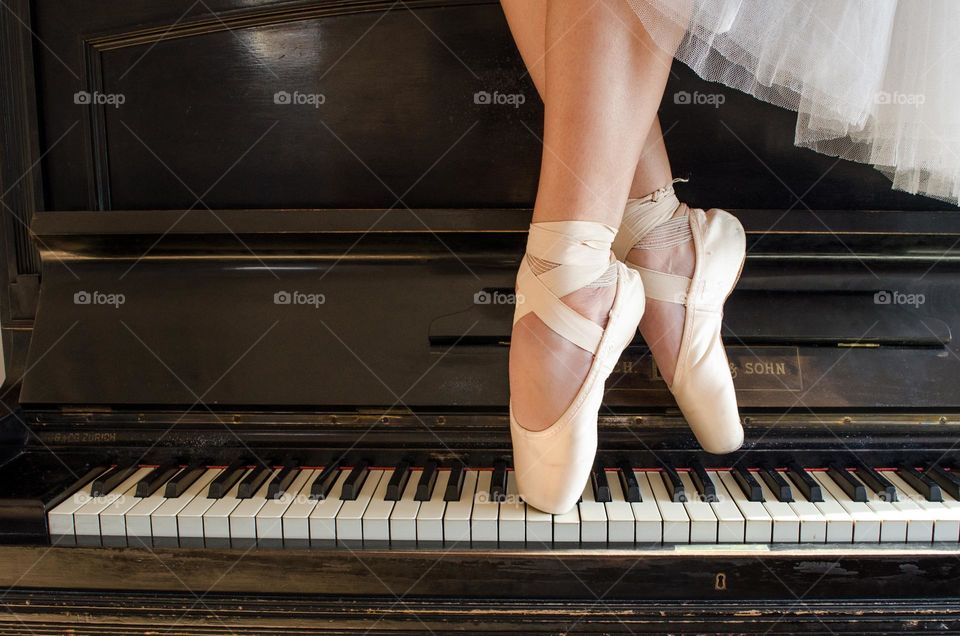 Ballerina Standing on A Piano