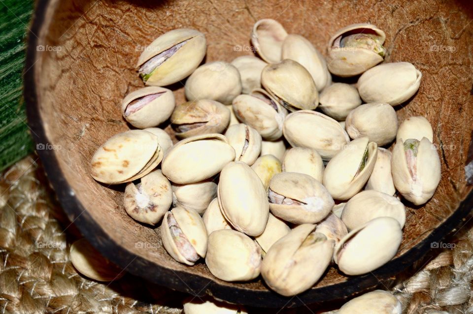 Pistachio nuts in coconut bowl