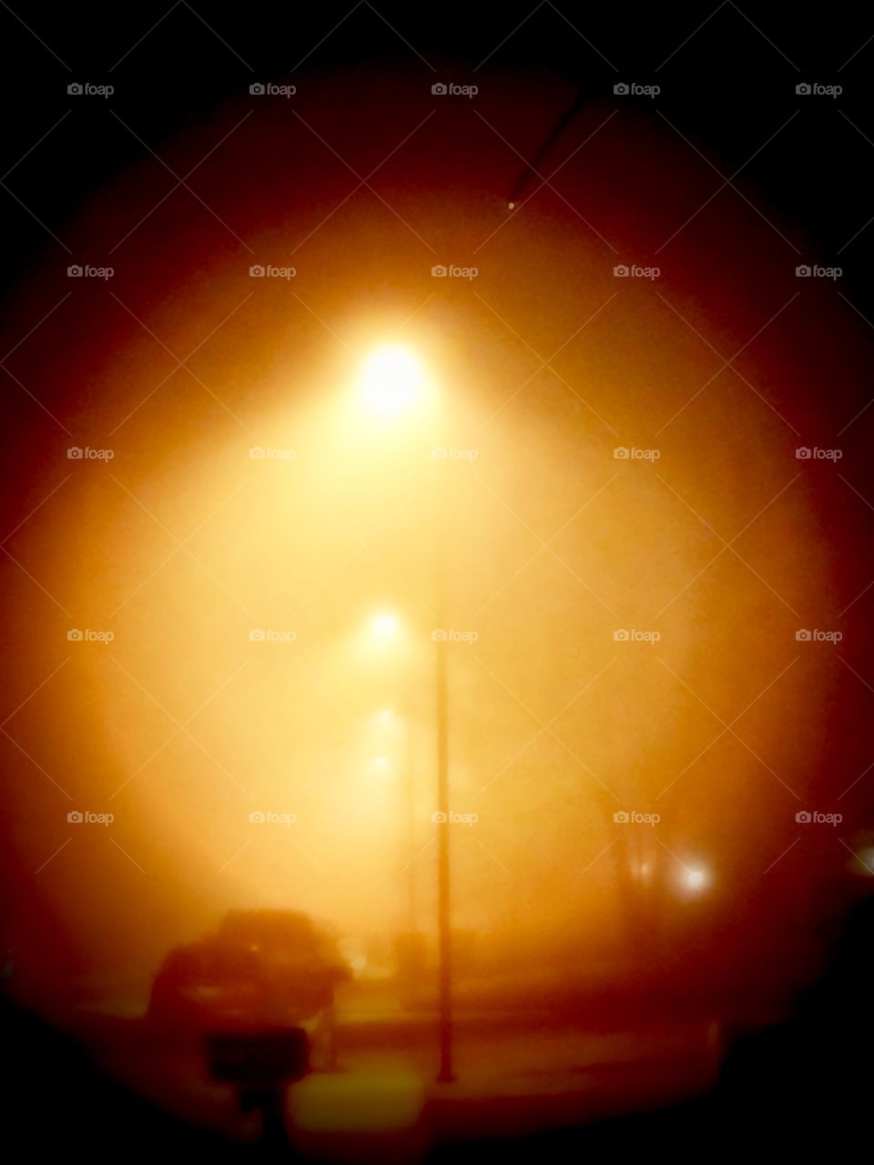 Orange Story
Heavy Fog  rolls in, encompassing streetlights, parked cars, and residential neighborhood.