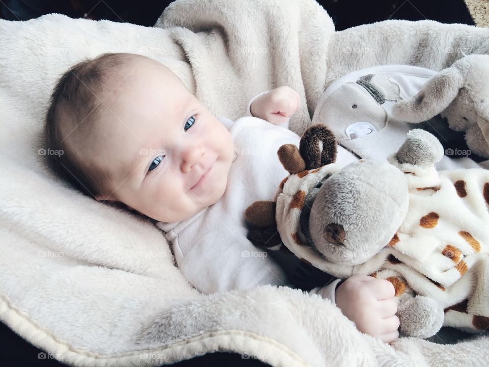 Smiling two month baby . Smiling two month baby with hippopotamus soft toy