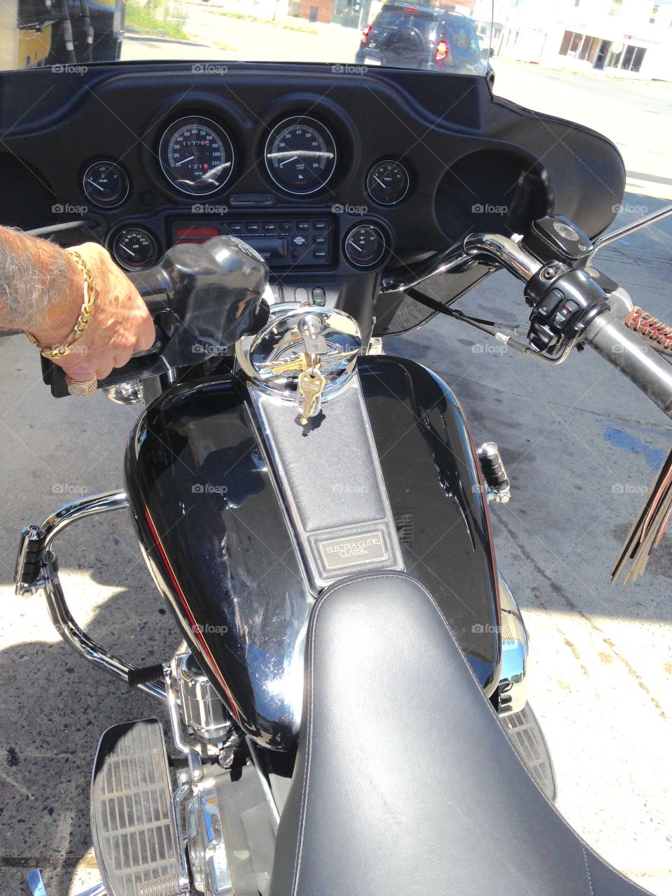 Filling Our Harley Gas Tank. Before riding we filled our 1999 Harley FLHTC gas tank. Pic shows most of the top side of our bike including gauges.