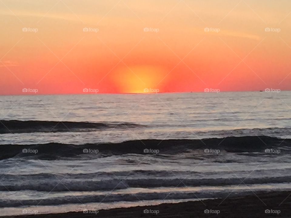 Waves at sea during sunset