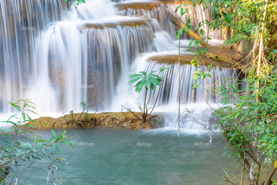 Waterfall flowing from the mountains at Huay Mae khamin waterfall National Park ,Kanchana buri in Thailand.