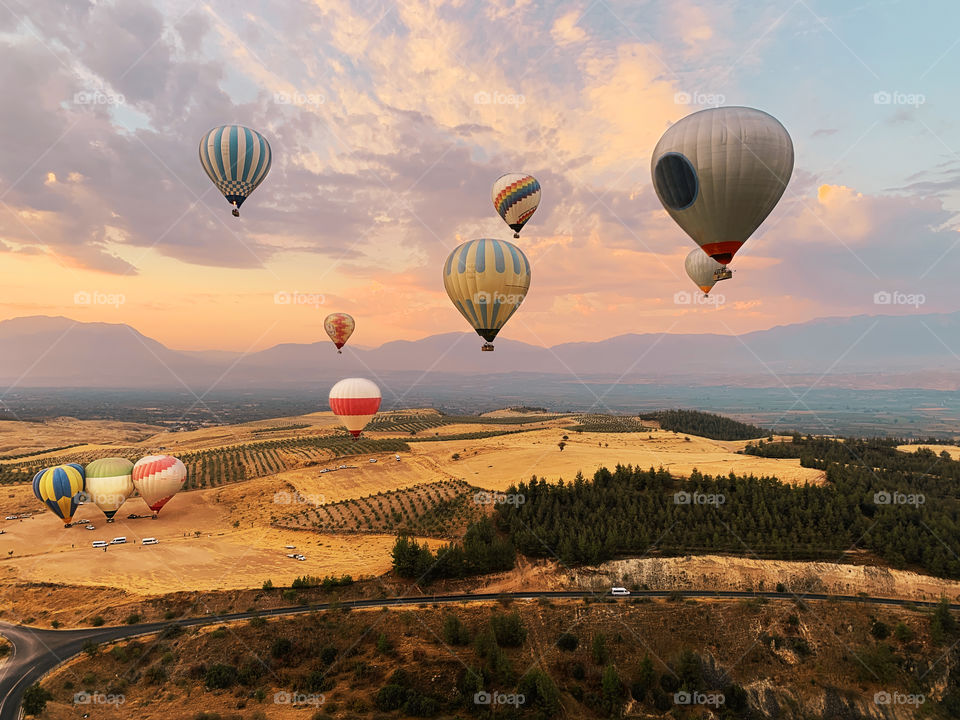 Hot air balloons flying over the beautiful landscape 