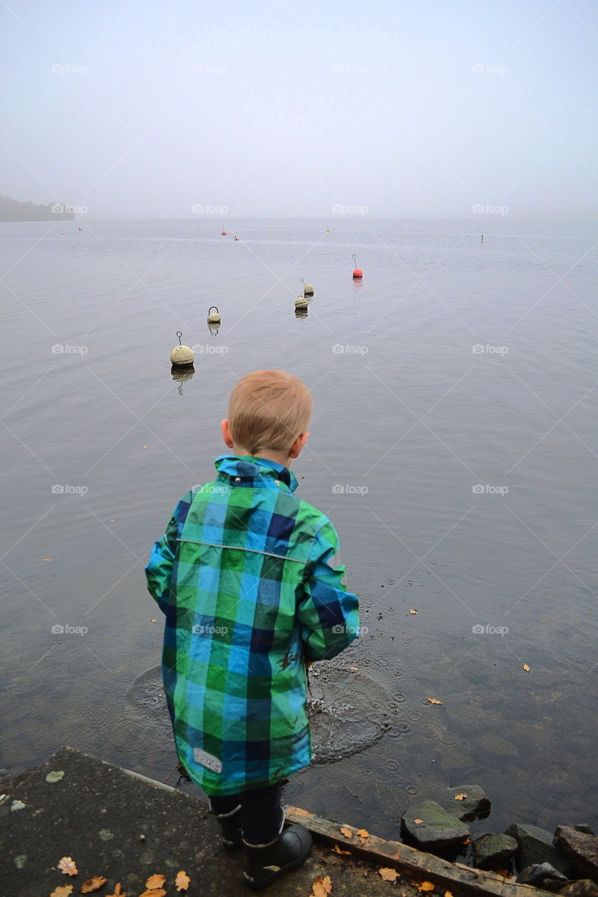 Boy playing at the lake