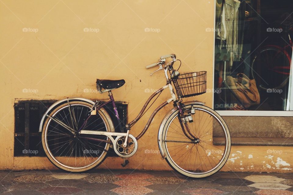 Bicycle against a yellow wall