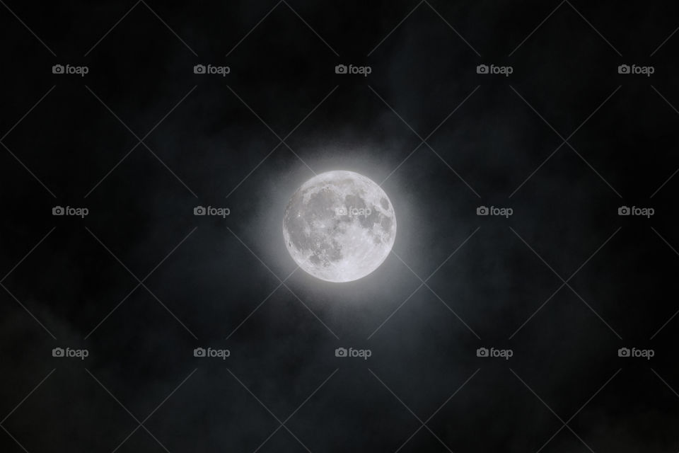 Full moon on clouds close-up