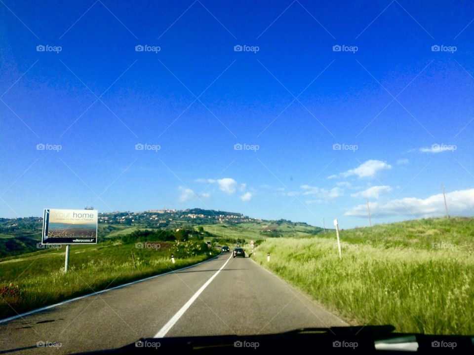 Tuscany countryside, road view, green fields and hills