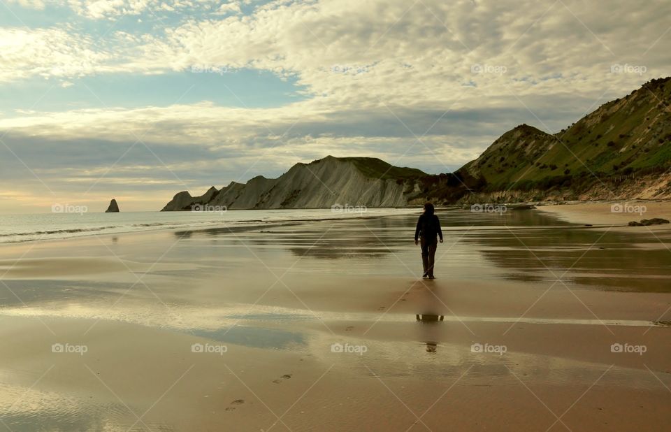 Silhouette of girl on New Zealand beach 
