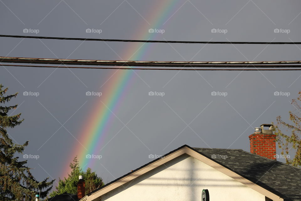 Rainbow popping up on the sky